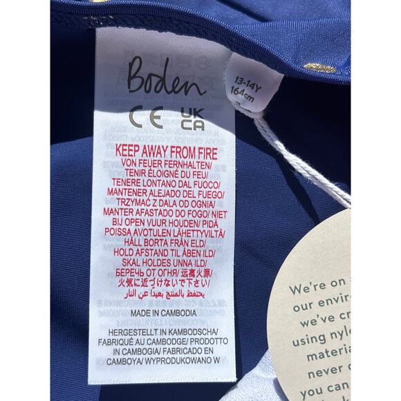 Mini Boden Cross-back Printed Swimsuit in Navy with Gold Foil Confetti Dot - Picture 7 of 9